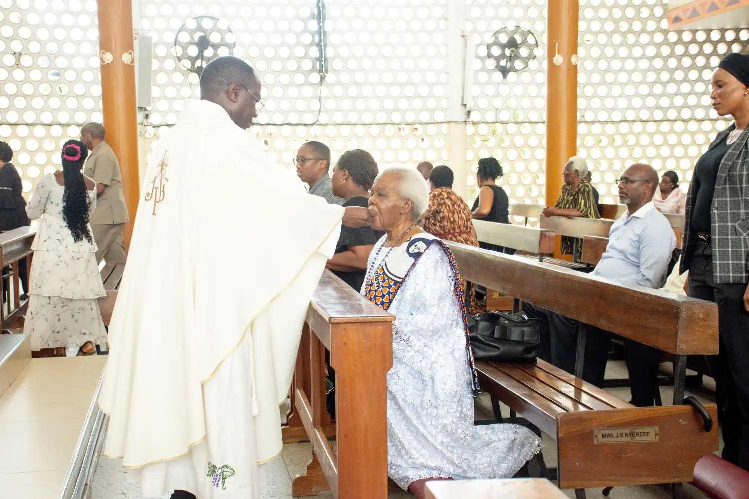 Mama Maria Nyerere receives Holy Communion during the Requiem Mass.
